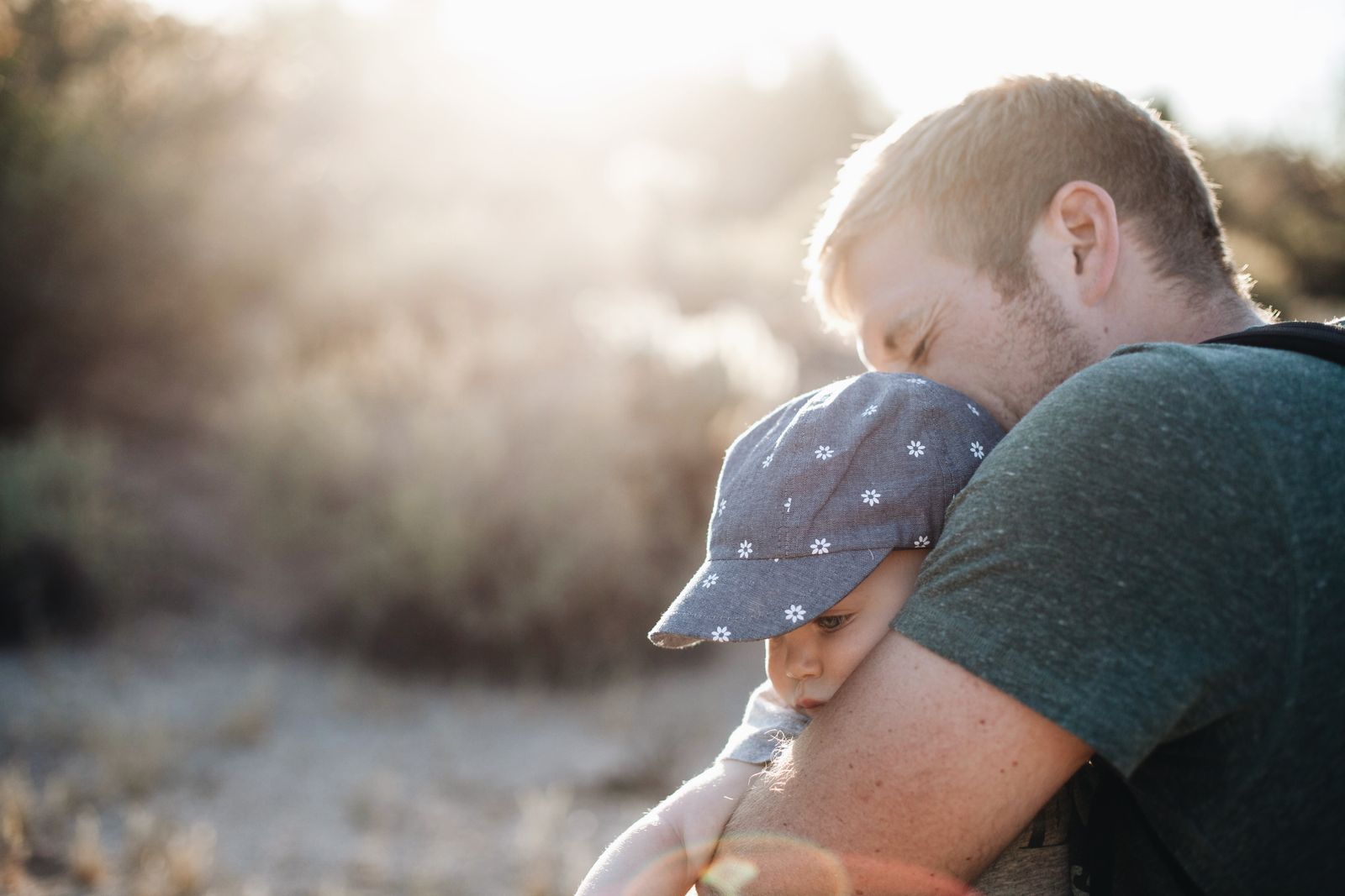 A parent holding a young child close